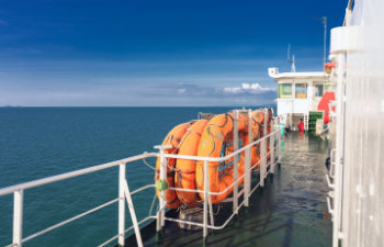 orange inflatable lifeboats on ferry deck for emergencies and maritime accidents
